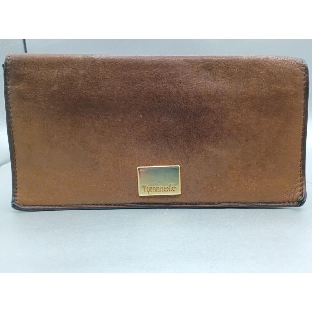 leather Tignanello wallet featuring a gold-toned logo plaque